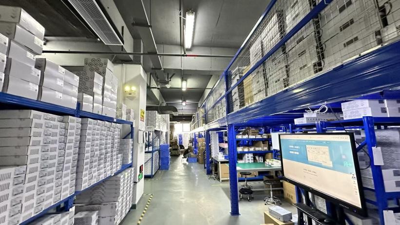 A storage aisle with packed cartons on shelving at CKCP